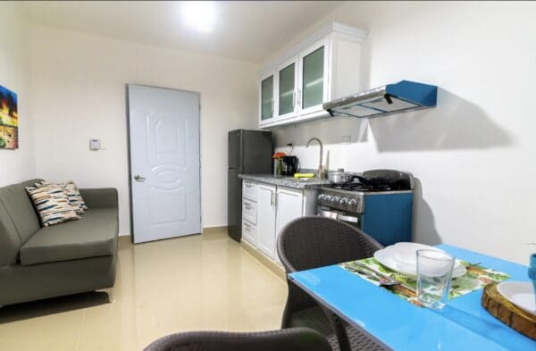 A kitchen with a table and chairs in it